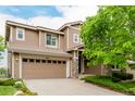 A well-maintained, two-story home featuring a two-car garage, stone accents, and a covered entryway at 3126 Aspen Creek Dr, Highlands Ranch, CO 80129