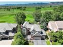 Beautiful home with meticulously landscaped yard backing onto a lush green golf course at 11904 W Auburn Dr, Denver, CO 80228