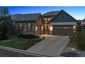 Attractive home featuring stone accents, three-car garage, complemented by a landscaped yard at 10687 Featherwalk Way, Highlands Ranch, CO 80126