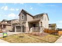 Charming home with a covered porch, three-car garage, and well-kept yard at 24325 E Ada Pl, Aurora, CO 80018
