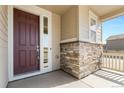 Welcoming front porch with stone accents, leading to the front door at 24325 E Ada Pl, Aurora, CO 80018
