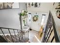 Charming entryway with staircase, stylish bench, and decorative wreath on the front door at 8280 Everett Way, Arvada, CO 80005