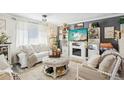 Cozy living room featuring a fireplace, gray accent wall, and curated decorative items at 8280 Everett Way, Arvada, CO 80005