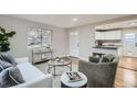 A living room with hardwood floors that opens to the kitchen at 5235 Dover St, Arvada, CO 80002