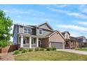 Well-maintained two-story home with a front porch and landscaped front yard at 3520 Desert Ridge Cir, Castle Rock, CO 80108