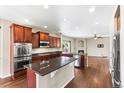 Open kitchen featuring stainless steel appliances, granite counters, and a center island at 3520 Desert Ridge Cir, Castle Rock, CO 80108