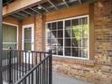 This exterior entrance features a secure door, window view, and brick exterior accents at 61 S Sable Blvd # C15, Aurora, CO 80012