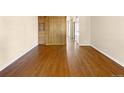 Bright living area featuring hardwood floors and a closet with built in drawers at 61 S Sable Blvd # C15, Aurora, CO 80012