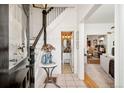 Bright foyer featuring stylish decor, a staircase, and a glimpse into adjacent living spaces at 432 N Ogden St, Denver, CO 80218