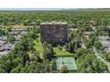 High rise building surrounded by mature trees and manicured lawn with tennis courts at 1900 E Girard Pl # 1103, Englewood, CO 80113