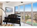 Bright room with grand piano and floor to ceiling windows offering panoramic city views at 1900 E Girard Pl # 1103, Englewood, CO 80113