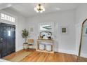 Bright entryway with hardwood floors, modern light fixture, and stylish décor at 748 Elati St, Denver, CO 80204