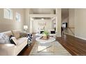 Spacious living room with modern furnishings, high ceilings, and seamless flow to the adjacent dining area at 3461 Maple Cir, Brighton, CO 80601