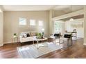 Bright living room with hardwood floors, modern furniture, and large windows that let in plenty of natural light at 3461 Maple Cir, Brighton, CO 80601
