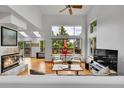 Bright living room with high ceilings, large windows, a fireplace, wood floors and comfortable seating at 766 Chimney Creek Dr, Golden, CO 80401