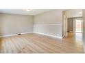 Spacious living room with pristine hardwood floors, neutral walls, and ample natural light, ready for personal touches at 3216 Revere St, Aurora, CO 80011