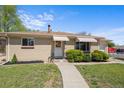 Charming one-story brick home with well-maintained lawn and awning-covered windows at 7736 Vallejo St, Denver, CO 80221