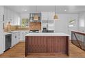 Bright kitchen featuring white cabinets, stainless steel appliances, and a butcher block island at 7736 Vallejo St, Denver, CO 80221