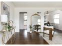 Bright living room featuring hardwood floors, a large gold mirror and access to the dining room at 3910 S Grant St, Englewood, CO 80113