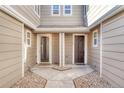 Townhome entrance featuring dual front doors, rock landscaping, and modern fixtures at 9023 Apache Plume Dr # C, Parker, CO 80134