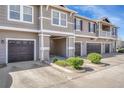 The exterior showcases a well-kept townhome complex with driveways, garages, and manicured shrubs at 9023 Apache Plume Dr # C, Parker, CO 80134