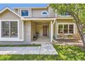 Inviting front porch with seating, a decorative wreath, and charming details enhancing the home's curb appeal at 5 Cliffrose, Littleton, CO 80127