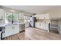 Modern kitchen with stainless steel appliances, white cabinetry and plenty of light at 2888 S Fundy St, Aurora, CO 80013