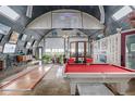 Spacious living area in a Quonset-style home with a pool table, skylights, and a projector screen at 410 Goodrich Ave, Platteville, CO 80651