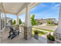 Inviting front porch with comfortable seating and neighborhood views at 20998 E 60Th Pl, Aurora, CO 80019