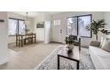 Inviting living room and dining area with a large window, stylish rug, and comfortable seating at 1700 W 102Nd Ave, Thornton, CO 80260