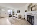 Bright living room featuring a fireplace, ample seating, large window, and modern decor at 1700 W 102Nd Ave, Thornton, CO 80260