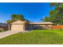 Charming single-story home with well-maintained lawn, attached two-car garage, and beautiful brick accents at 3643 E Lake Dr, Centennial, CO 80121