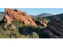 House nestled in a scenic locale near Red Rocks, providing picturesque views of the community at 8244 S Queen St, Littleton, CO 80127
