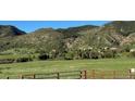 Rural land with views of nearby homes and sloping hillsides at 8244 S Queen St, Littleton, CO 80127