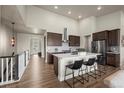 Open kitchen features a large island with seating, modern appliances, and a walk-in pantry at 8244 S Queen St, Littleton, CO 80127