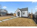 Charming home with modern landscaping and a walkway to the front door at 75 S Knox Ct, Denver, CO 80219