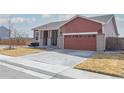 Inviting home with a spacious driveway, attached two-car garage, and a well-manicured front yard with mature trees at 13601 Krameria St, Thornton, CO 80602
