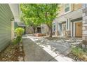 Landscaped courtyard with shade trees and seating area at 3329 Molly Ln, Broomfield, CO 80023