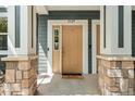 Charming front entrance with a welcoming doormat and stone details at 3329 Molly Ln, Broomfield, CO 80023