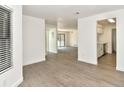 Open floor plan featuring modern flooring leads from a bright living area to the updated kitchen at 12024 W Cross Dr # 106, Littleton, CO 80127