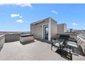 Rooftop deck with a hot tub, seating area, and stunning views of the city skyline at 15732 E Broncos Pl, Englewood, CO 80112