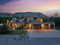 Modern home with an attached three-car garage, stone accents, a low-maintenance lawn and mountain views at 5123 Quaker St, Golden, CO 80403