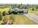 Scenic aerial view of a home with a well-manicured lawn and mature trees in a peaceful setting at 9232 N Surrey Dr, Castle Rock, CO 80108