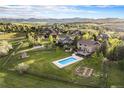 Expansive property featuring a pool, large yard, garden, and mountain views at 7624 Russell Ct, Arvada, CO 80007
