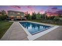 Backyard view of a sparkling in-ground pool, deck, and garden at 7624 Russell Ct, Arvada, CO 80007