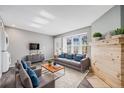 Cozy living room featuring comfortable seating, a wood-trimmed fireplace, and a view to the outside at 3090 W 107 Pl # F, Westminster, CO 80031
