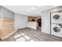 Open-concept living room leading to the kitchen and featuring wood floors and laundry hookups at 3090 W 107 Pl # F, Westminster, CO 80031