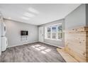 Bright living room showcasing laminate wood floors, a rustic fireplace, and natural light at 3090 W 107 Pl # F, Westminster, CO 80031
