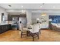 Stylish dining area adjacent to the kitchen with modern lighting and comfortable seating for a cozy meal setting at 2815 W 52Nd Ave, Denver, CO 80221