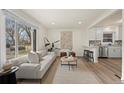 Open concept living area flows to the kitchen with stainless steel appliances at 4573 S Acoma St, Englewood, CO 80110